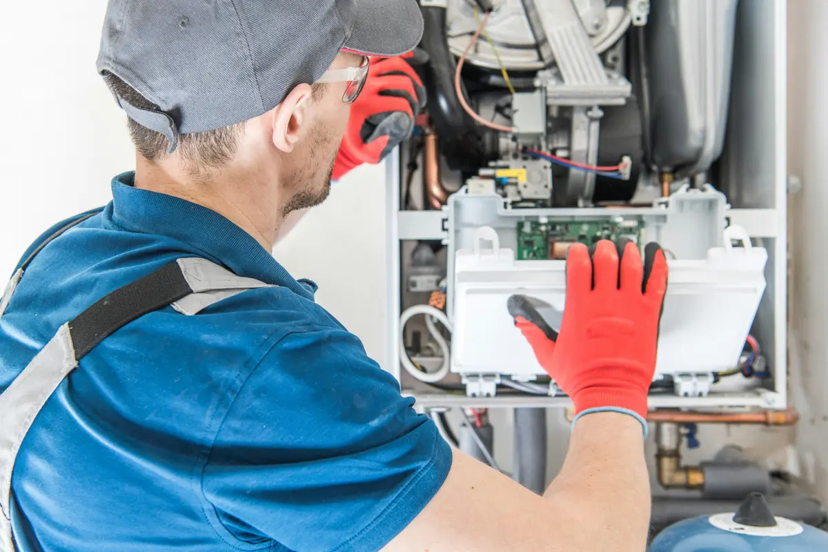 HVAC technician performing annual maintenance on a boiler in Houston