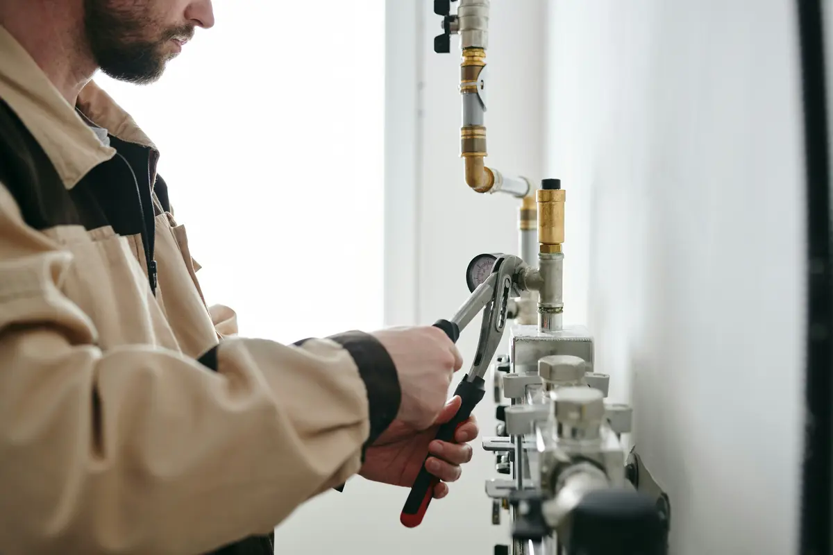 HVAC technician working on natural gas piping installation
