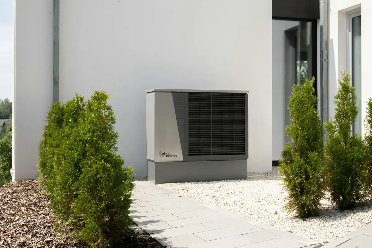 Cold-climate heat pump outdoor unit mounted on Houston home exterior