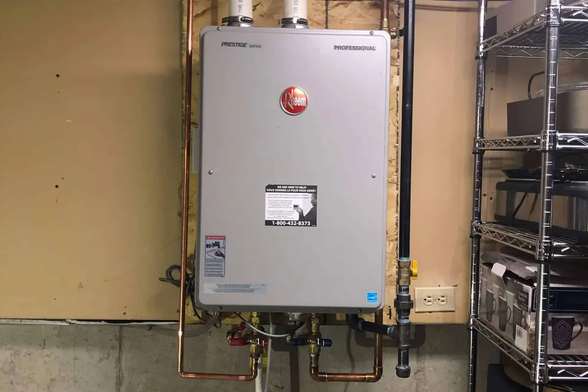 Rheem tankless water heater installed on a wall in a Houston basement