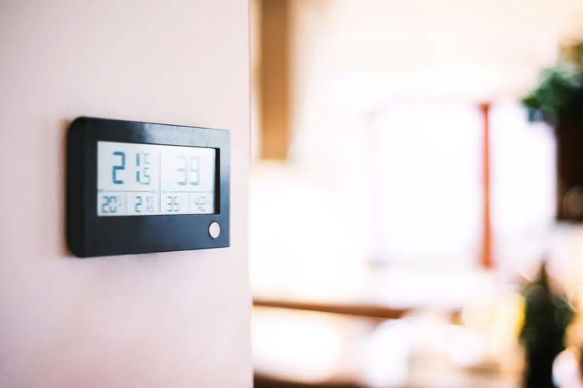 Modern smart thermostat on a residential wall in Houston
