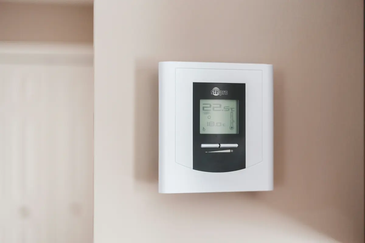 Smart thermostat installed on wall in a Houston home